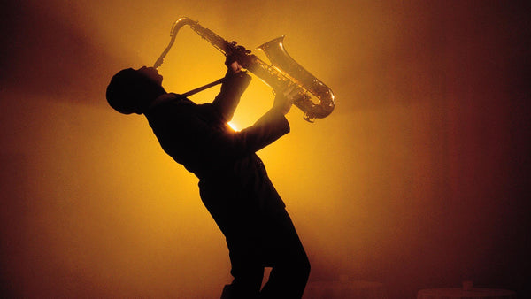 Silhouette of man playing the sax